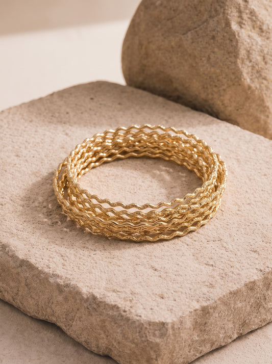 Braided gold-plated bangle by DERAC
